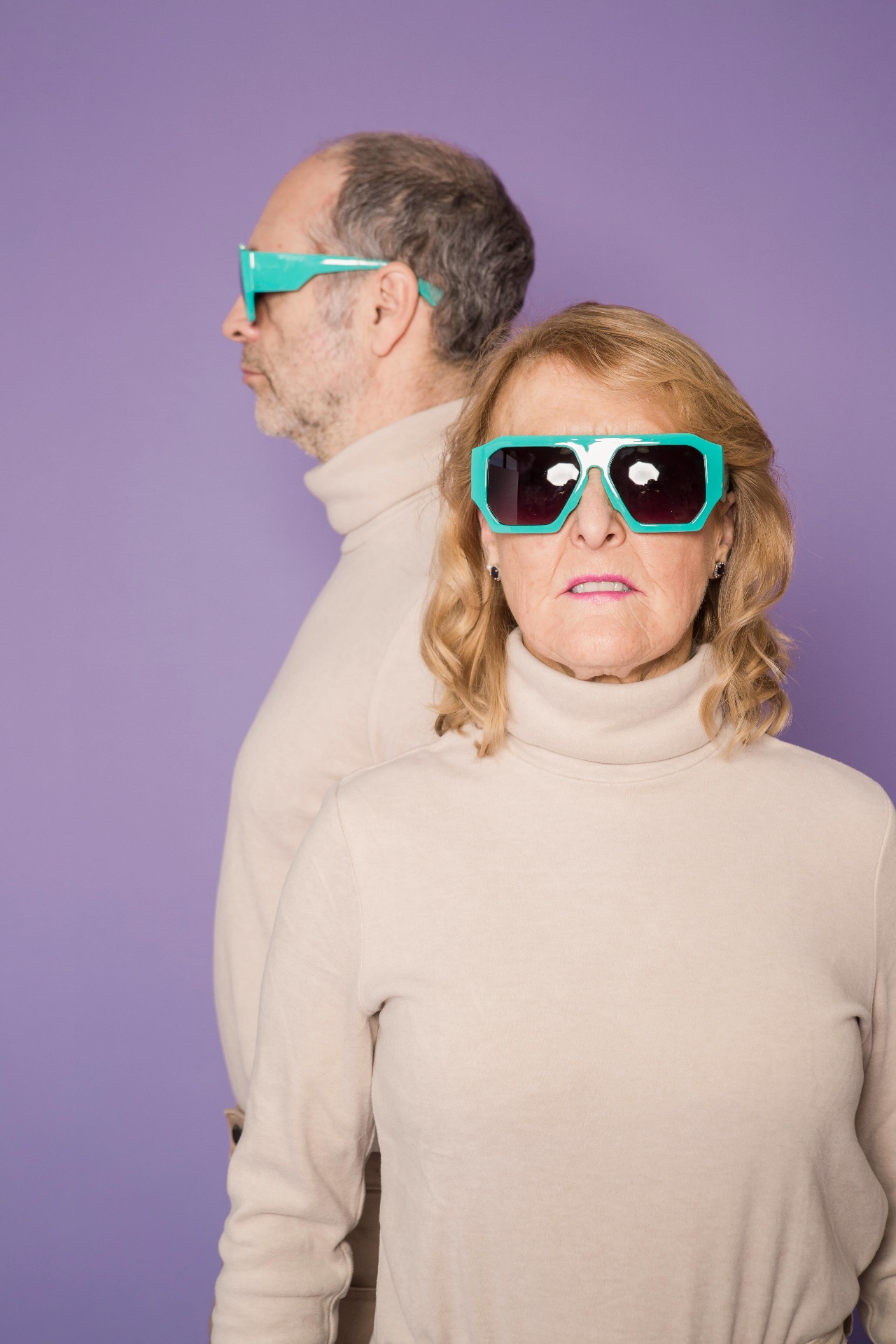 Two people in matching turquoise sunglasses — bonded across generations